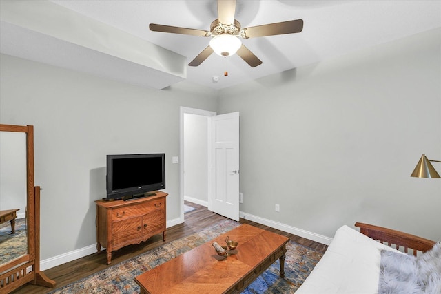 living room featuring dark hardwood / wood-style floors and ceiling fan