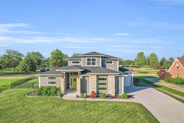 view of front of house featuring a garage and a front lawn