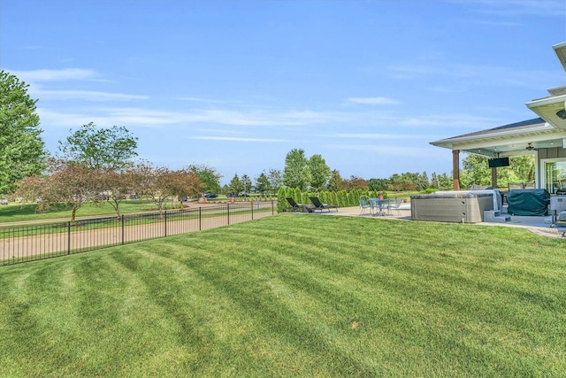 view of yard featuring a patio area and a hot tub