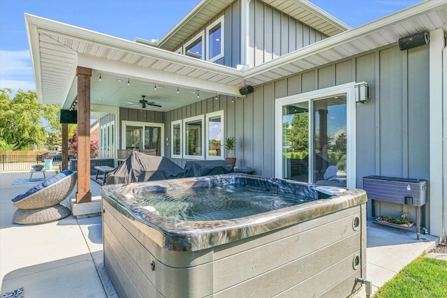 view of patio featuring ceiling fan and a hot tub