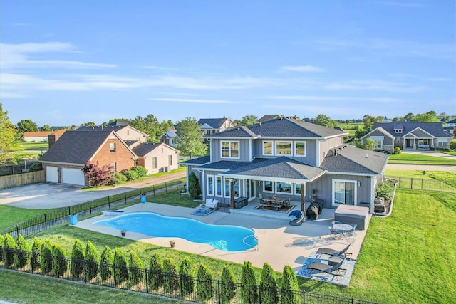 back of house with a fenced in pool, a yard, a patio area, and outdoor lounge area