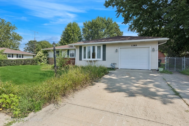 ranch-style house with a garage and a front yard