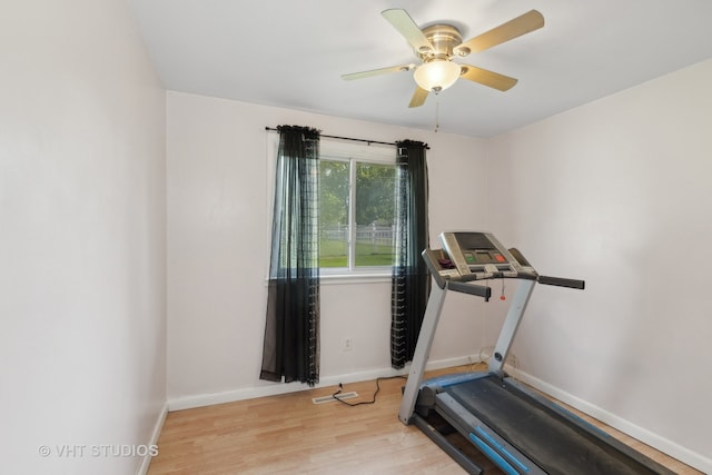 workout room with ceiling fan and light hardwood / wood-style flooring