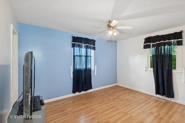 empty room featuring ceiling fan and wood-type flooring