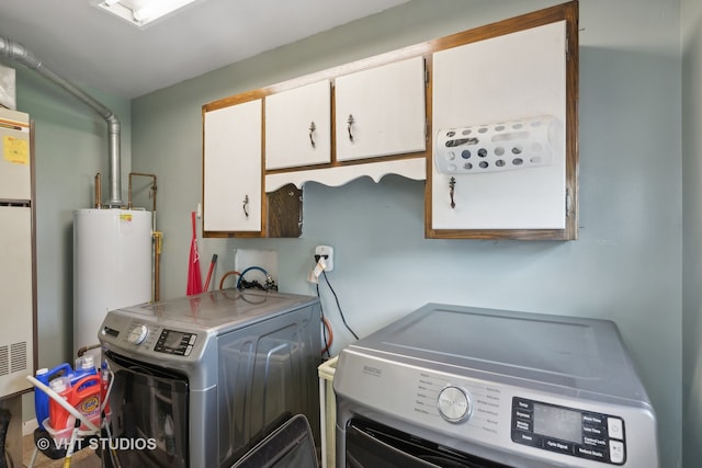 interior space with gas water heater, independent washer and dryer, and cabinets