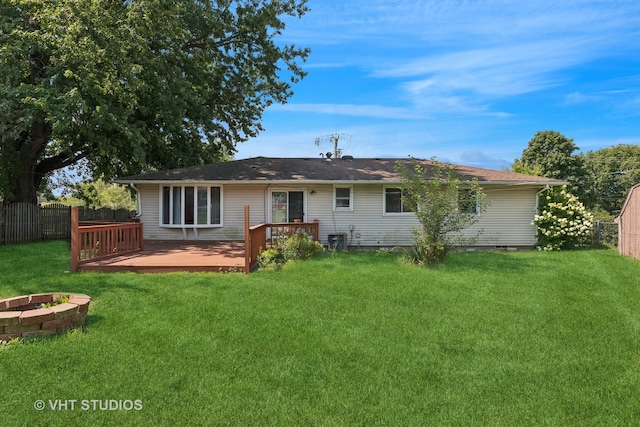 back of property featuring a yard and a deck