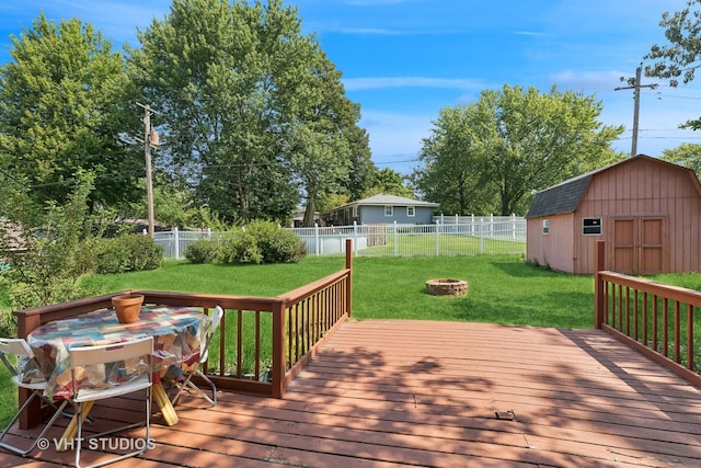 wooden deck with a shed and a lawn