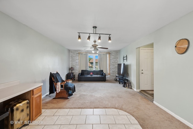 tiled living room with ceiling fan and rail lighting