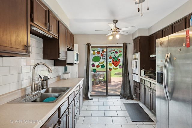 kitchen featuring ceiling fan, tasteful backsplash, sink, light tile patterned flooring, and white appliances