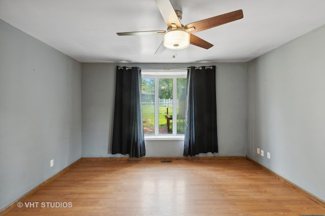 empty room with light hardwood / wood-style floors and ceiling fan