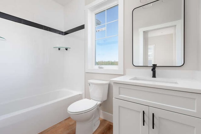 full bathroom with toilet, vanity, tub / shower combination, and hardwood / wood-style flooring