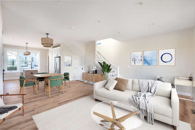 living room featuring light hardwood / wood-style floors and sink