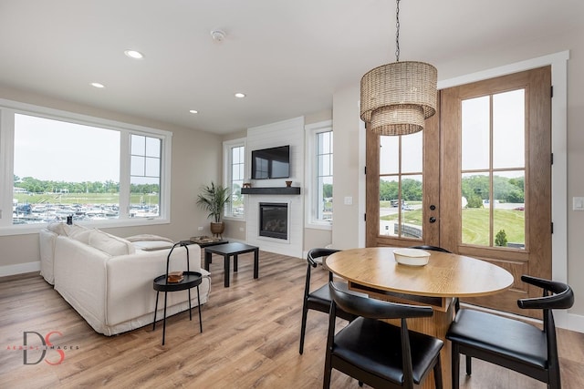 208 Leeward Way, Ottawa, IL 61350 - dining room featuring light wood-style flooring, a fireplace, and recessed lighting