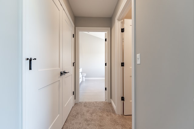 corridor with light colored carpet