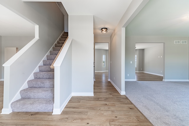 stairway with hardwood / wood-style flooring