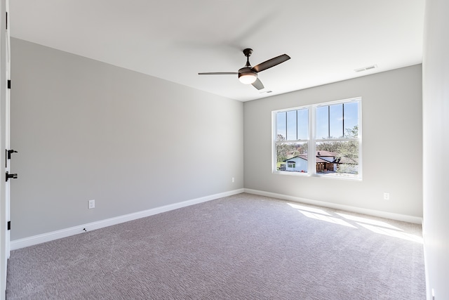 carpeted spare room with ceiling fan