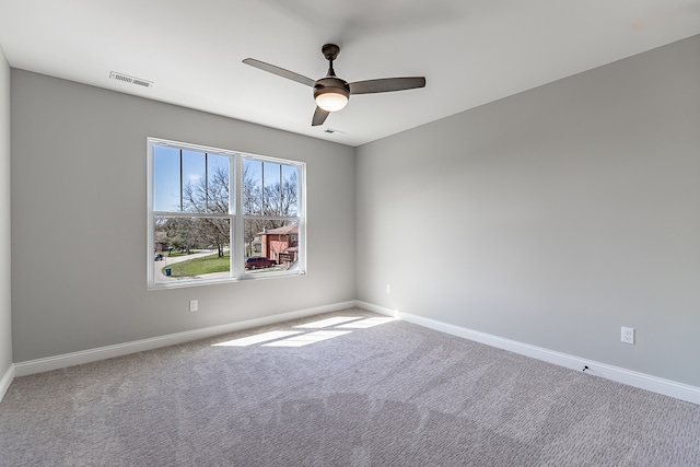 carpeted spare room with ceiling fan