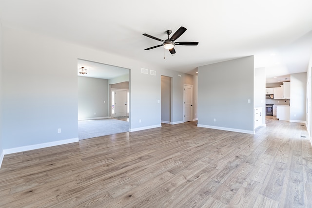 interior space featuring light hardwood / wood-style floors, sink, and ceiling fan