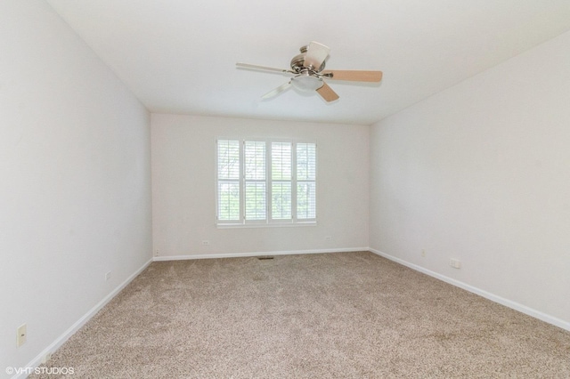 211 Grand Ridge Rd, Saint Charles, IL 60175 - unfurnished room with light colored carpet, baseboards, and a ceiling fan