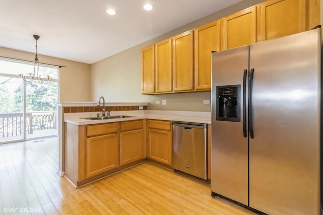 211 Grand Ridge Rd, Saint Charles, IL 60175 - kitchen featuring appliances with stainless steel finishes, a sink, light countertops, a peninsula, and light wood-style floors