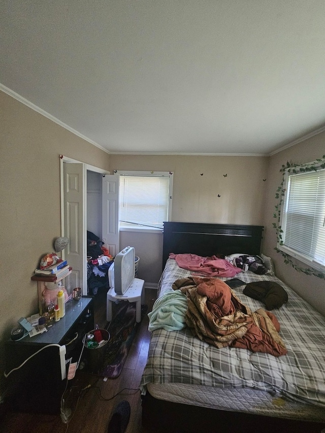 bedroom with hardwood / wood-style floors and crown molding