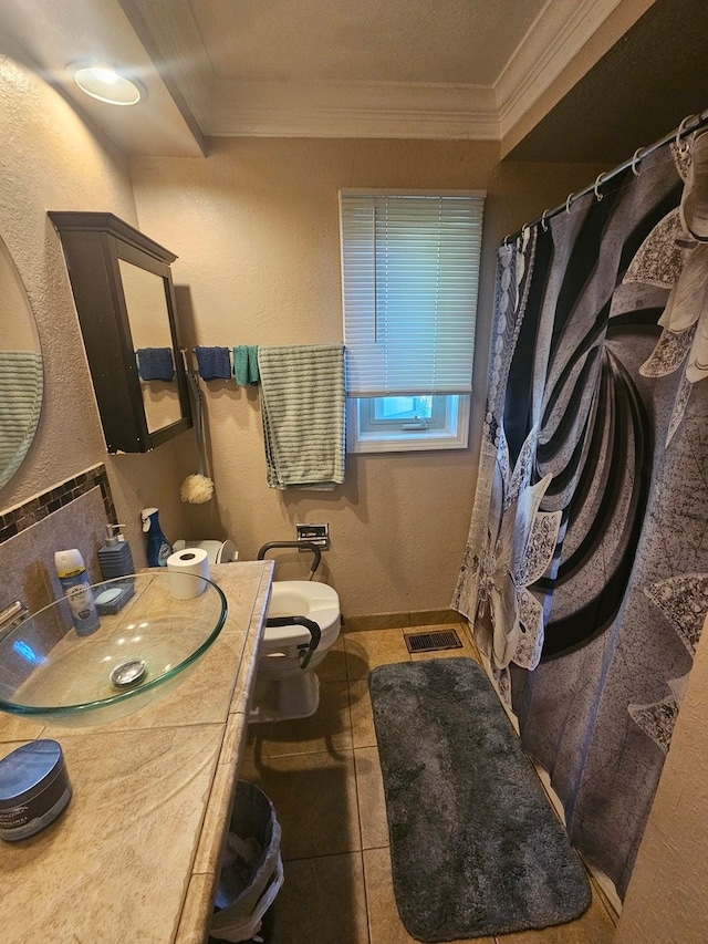 bathroom with tile floors, crown molding, toilet, and vanity