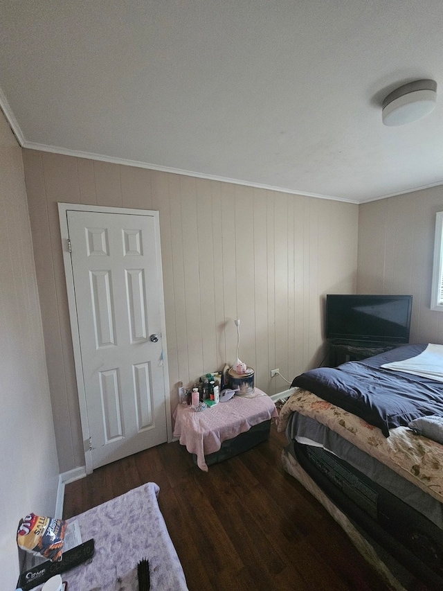 bedroom featuring dark wood-type flooring and crown molding