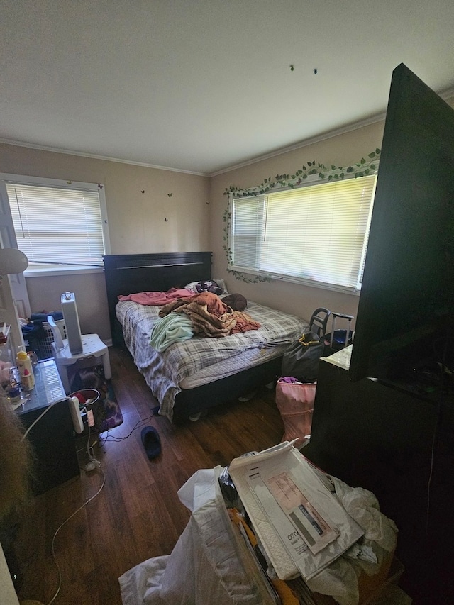 bedroom featuring crown molding and hardwood / wood-style flooring