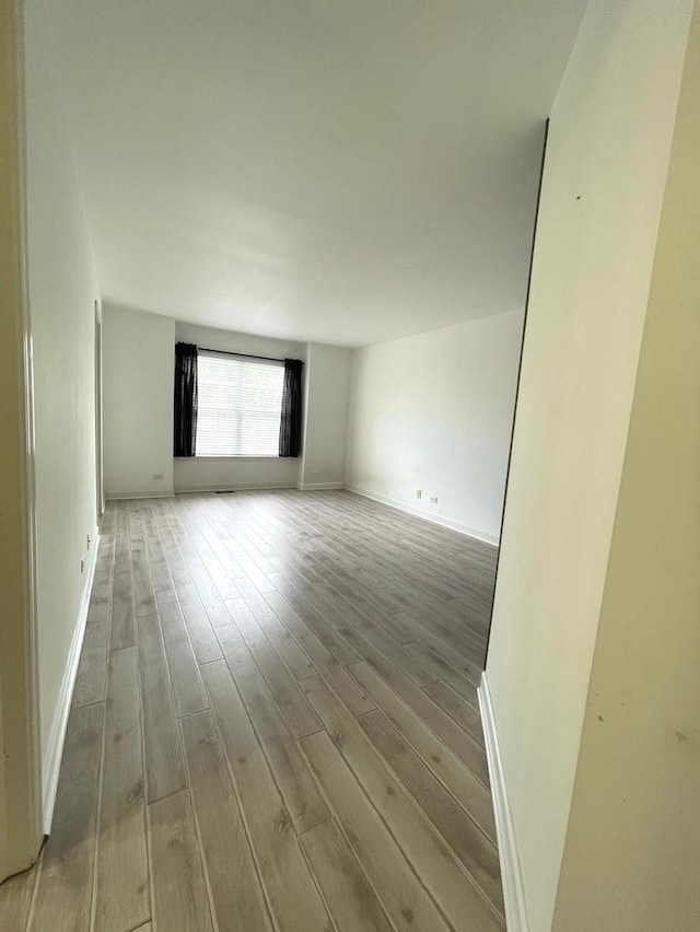 spare room with light wood-type flooring