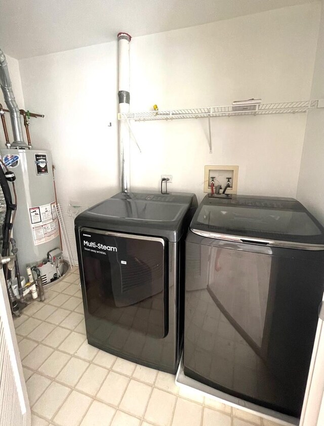 laundry area with separate washer and dryer and gas water heater