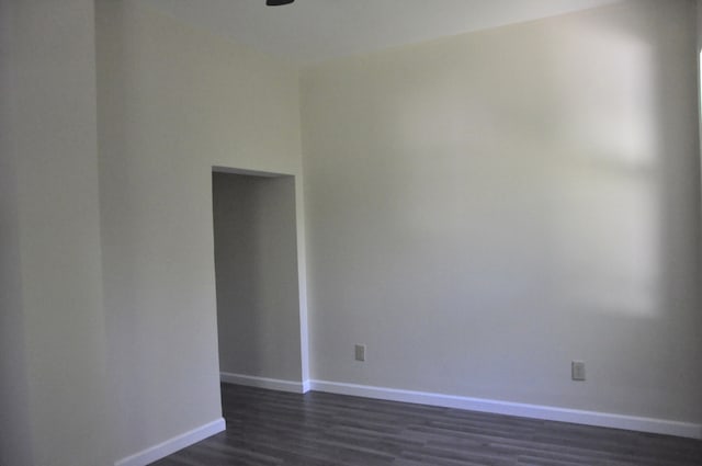 empty room with dark wood-type flooring