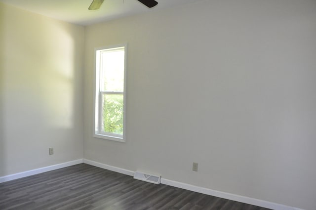 empty room with ceiling fan and dark hardwood / wood-style floors