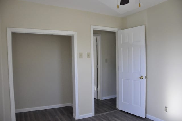 unfurnished bedroom featuring ceiling fan and dark hardwood / wood-style floors