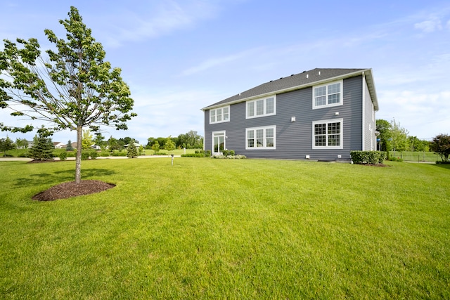 back of house featuring a lawn