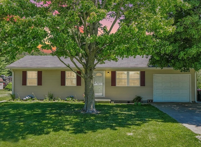 ranch-style house featuring a lawn and a garage