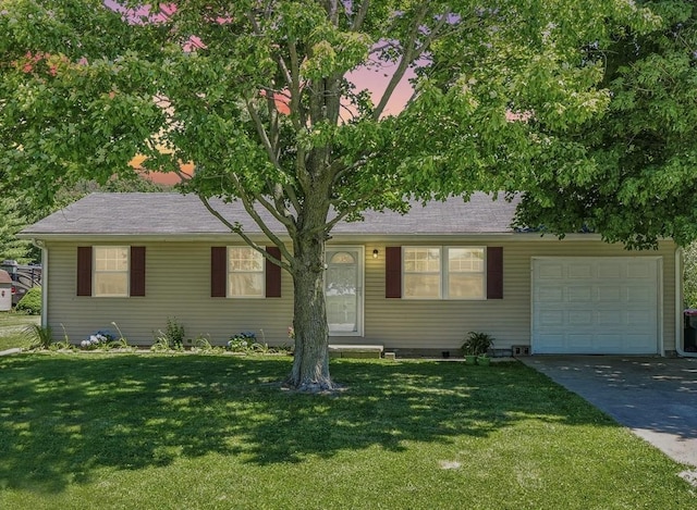 view of front of house featuring a front yard, concrete driveway, and an attached garage