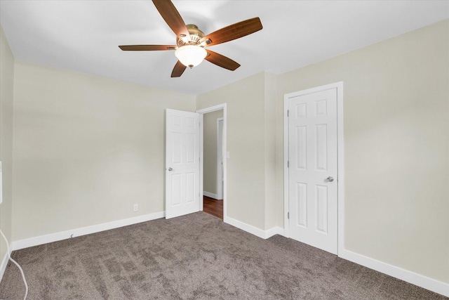 unfurnished bedroom featuring dark colored carpet and ceiling fan