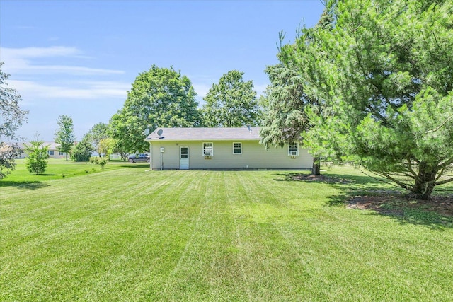 rear view of house featuring a yard