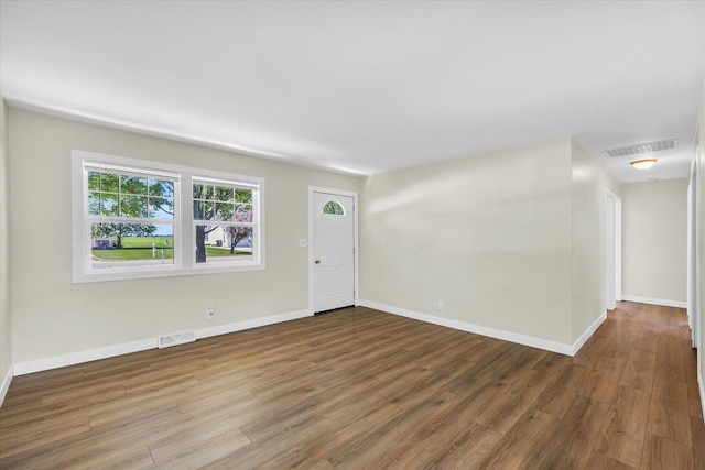 interior space with wood finished floors, visible vents, and baseboards