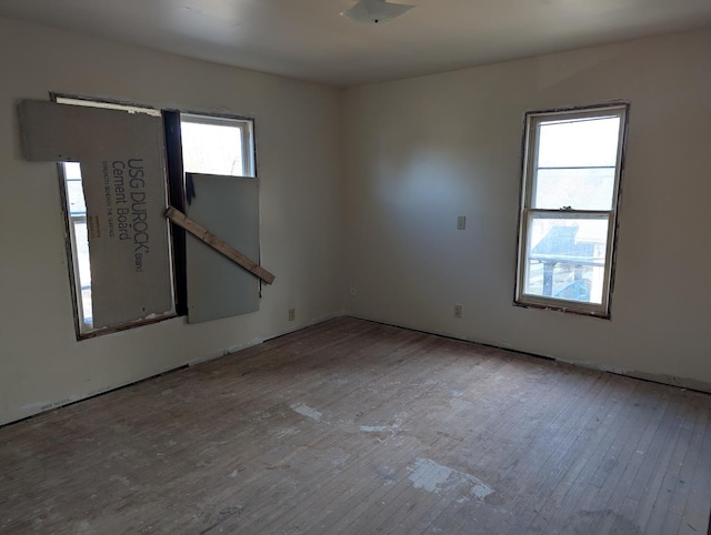 unfurnished room featuring light hardwood / wood-style flooring and a healthy amount of sunlight