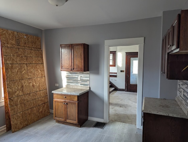 kitchen featuring light colored carpet and tasteful backsplash