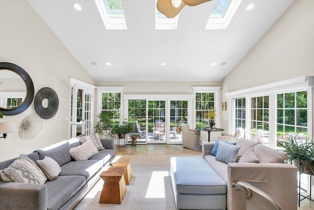 living area with high vaulted ceiling, a skylight, and recessed lighting