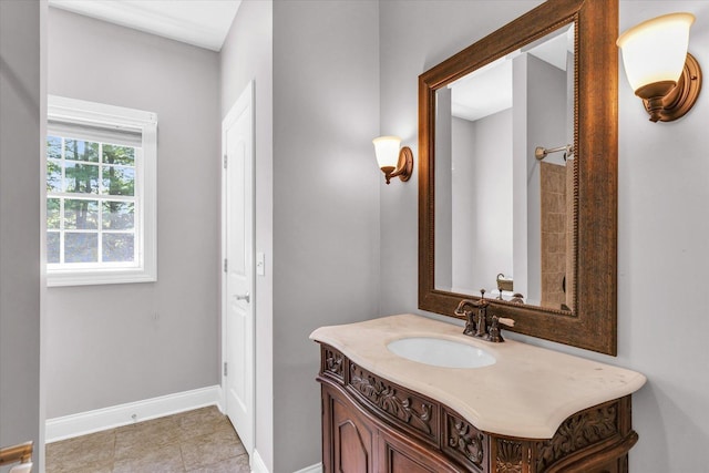 bathroom with tile patterned flooring, vanity, and baseboards