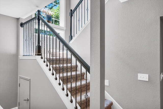 stairs featuring a high ceiling