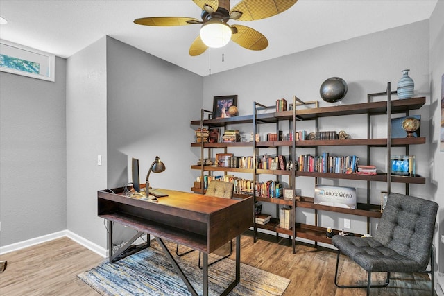 office space with ceiling fan, wood finished floors, and baseboards