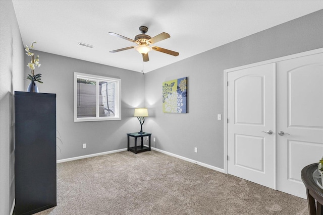 interior space featuring ceiling fan, a closet, visible vents, and baseboards