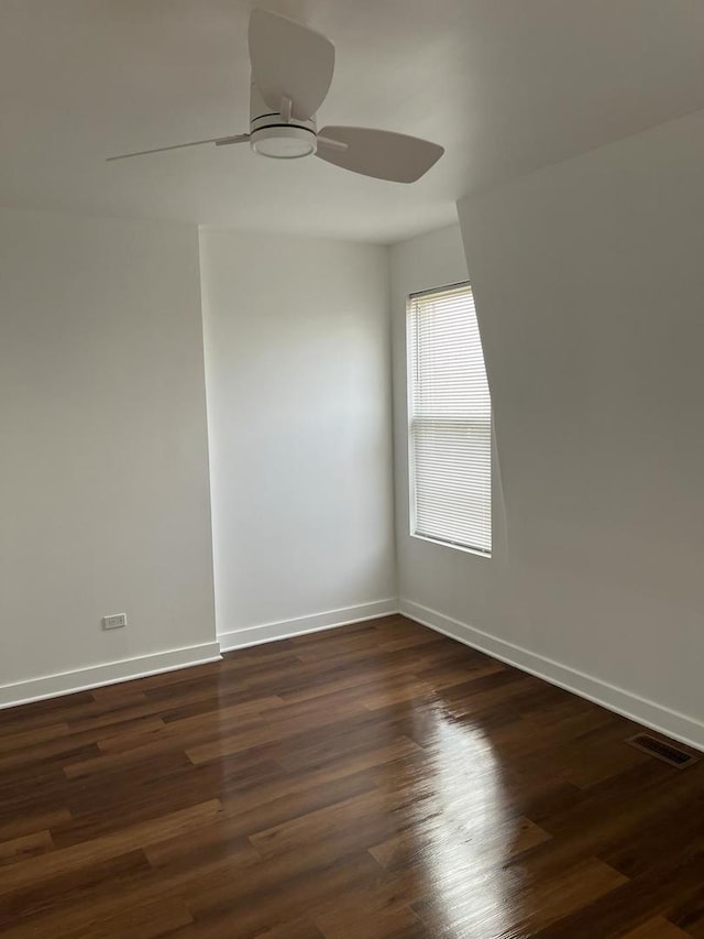 unfurnished room featuring ceiling fan and dark hardwood / wood-style flooring