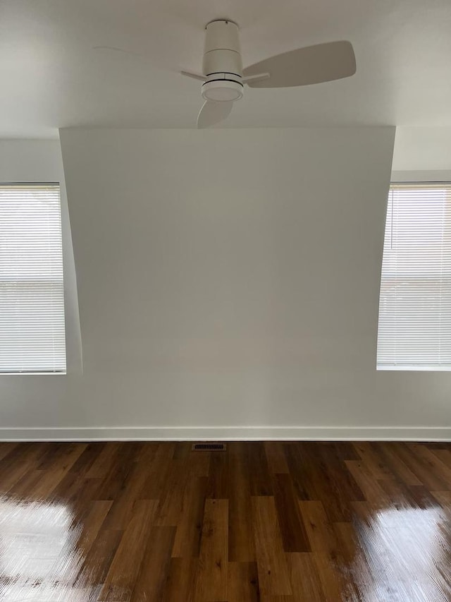 unfurnished room with dark hardwood / wood-style floors and ceiling fan