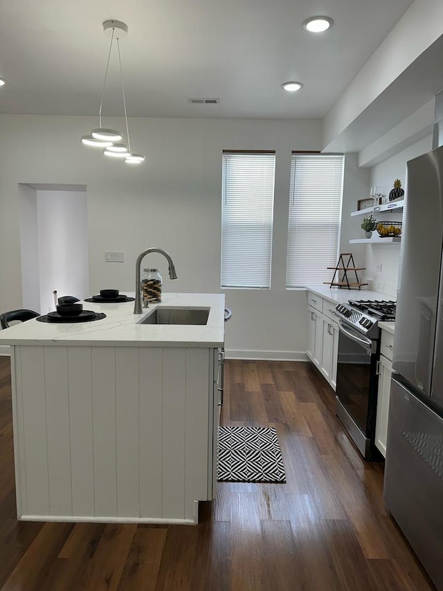 kitchen featuring decorative light fixtures, dark hardwood / wood-style flooring, stainless steel appliances, white cabinetry, and sink