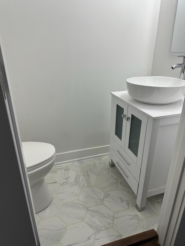 bathroom with tile floors, toilet, and vanity